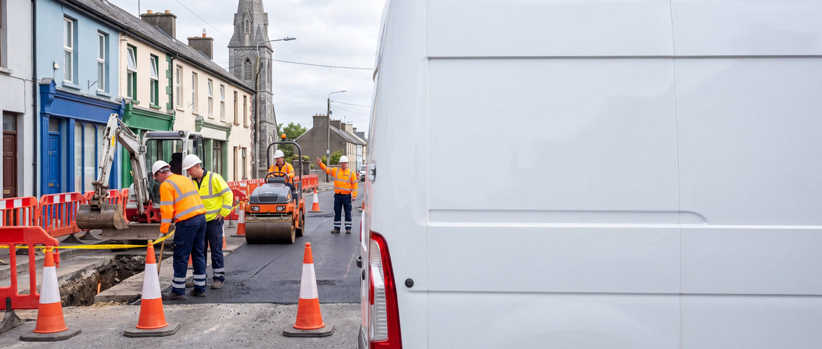 Road resurfacing crew in hi-vis workwear on an Irish town street